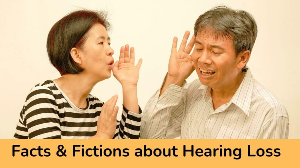 Asian man and woman trying to hear each other